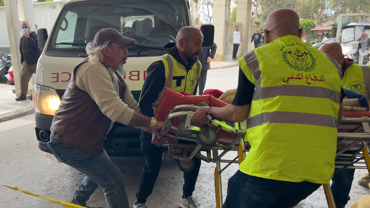 Rescue workers carry an injured man to a hospital emergency entrance after an Israeli airstrike hit a crowded neighborhood in southern Beirut, Sunday, April 5, 2026.