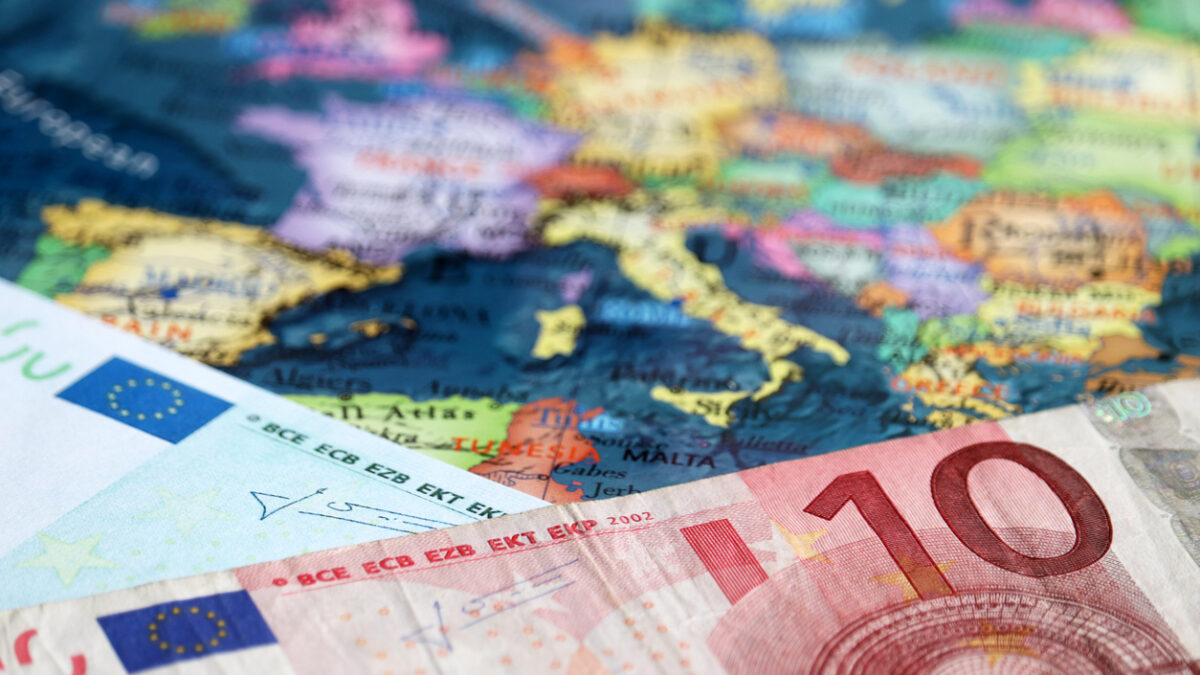 Euro banknotes on the map of Europe, selective focus. Concept for european economy, eurozone countries