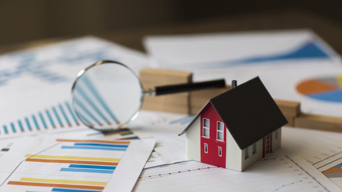 Miniature House on A Financial Graph