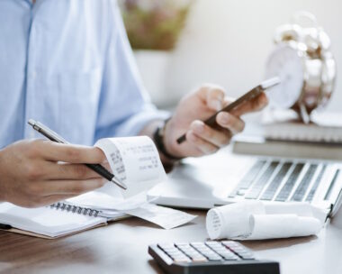 young man holding pen with bills working for calculate business data, taxes, bills payment, Start up counting finance. accounting, statistics, and analytic research concept