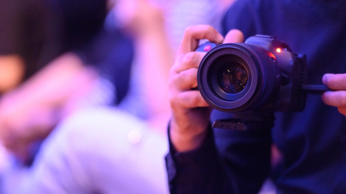 Unrecognizable professional photographer at work during fashion show, Nikon Z7