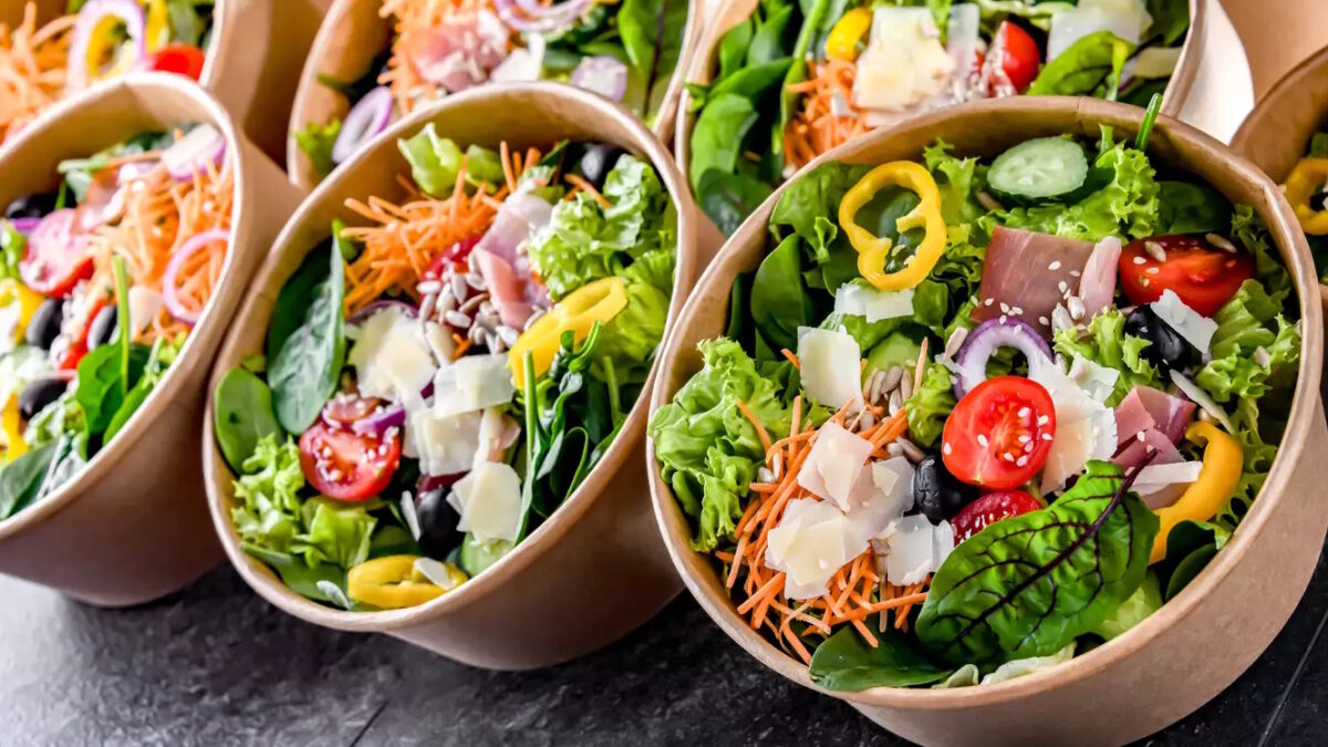 Round paper boxes with pre-packaged vegetable salads ready for sale