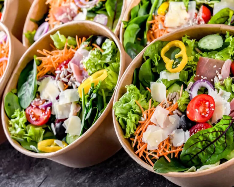 Round paper boxes with pre-packaged vegetable salads ready for sale
