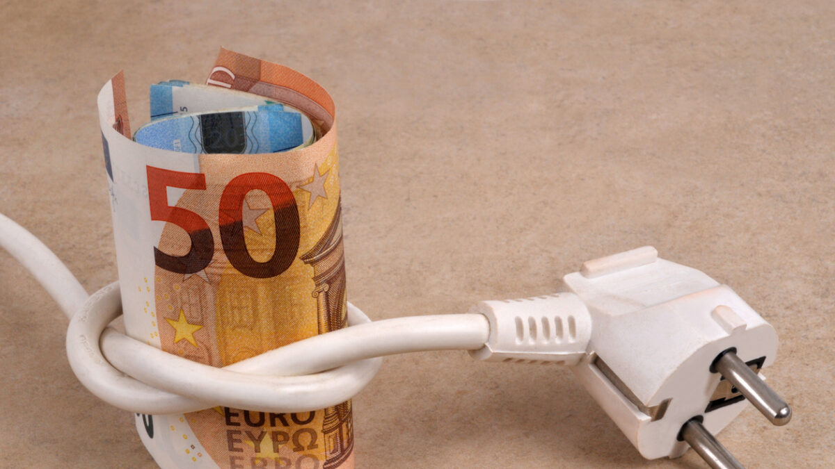 Electricity expense concept with a roll of euro banknotes surrounded by an electrical outlet