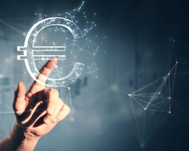 Close up of male hand pointing at creative polygonal euro sign on gray wall background. Online banking, money and trade concept