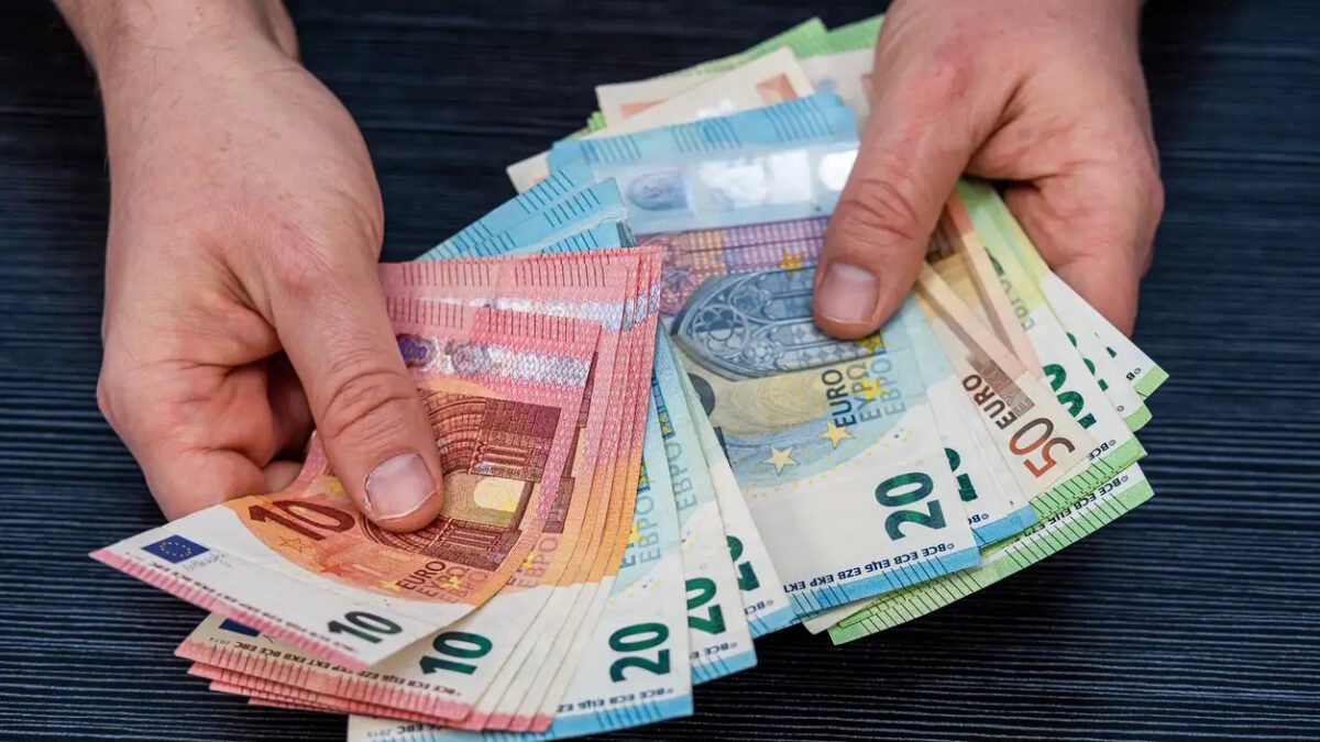 Man hold count euro money banknotes on black background. Financial concept