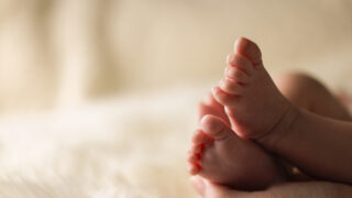 A close-up of tiny baby feet