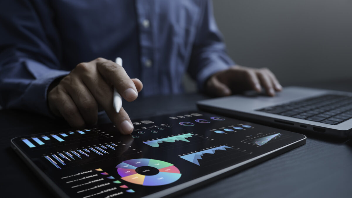 An analyst uses a computer and dashboard for data business analysis and Data Management System with KPI and metrics connected to the database for technology finance, operations, sales, marketing