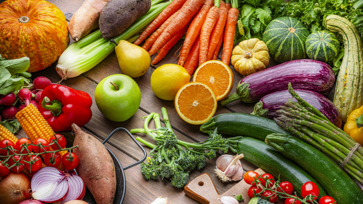 Freshly picked organic fruits and vegetables on kitchen table. Preparing healthy vegetarian meal with juicy ingredients. Food to improve the inmune system.