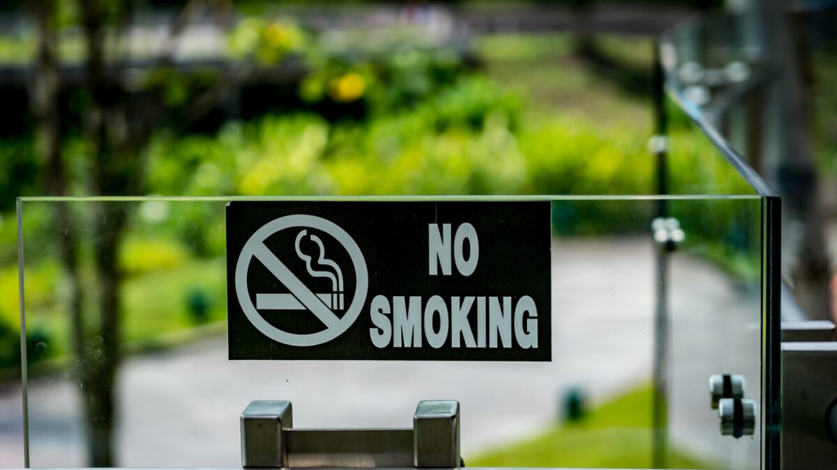 Black No smoking sign on modern glass and stainless railing