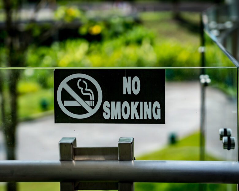 Black No smoking sign on modern glass and stainless railing