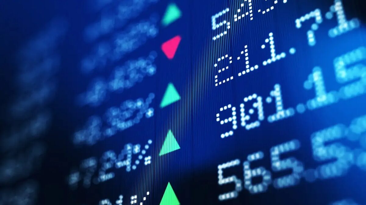 Financial data analysis graph showing stock market trends on a trading board. Horizontal composition with copy space and selective focus