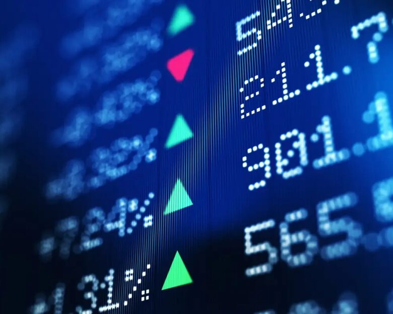 Financial data analysis graph showing stock market trends on a trading board. Horizontal composition with copy space and selective focus