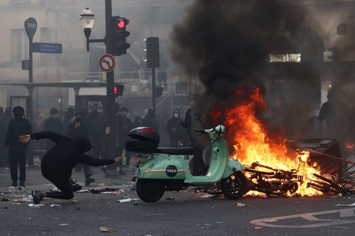 Protesters stand next to burning objects in a street amid clashes during a day of demonstrations against the cost of living and rising fuel prices in Paris as part of nationwide protests called by the "Yellow Vests" movement, joined by French high school and university students, teachers and parents demanding better school conditions and government action, as well as labour unions, workers, farmers and retirees, France, October 17, 2026. REUTERS