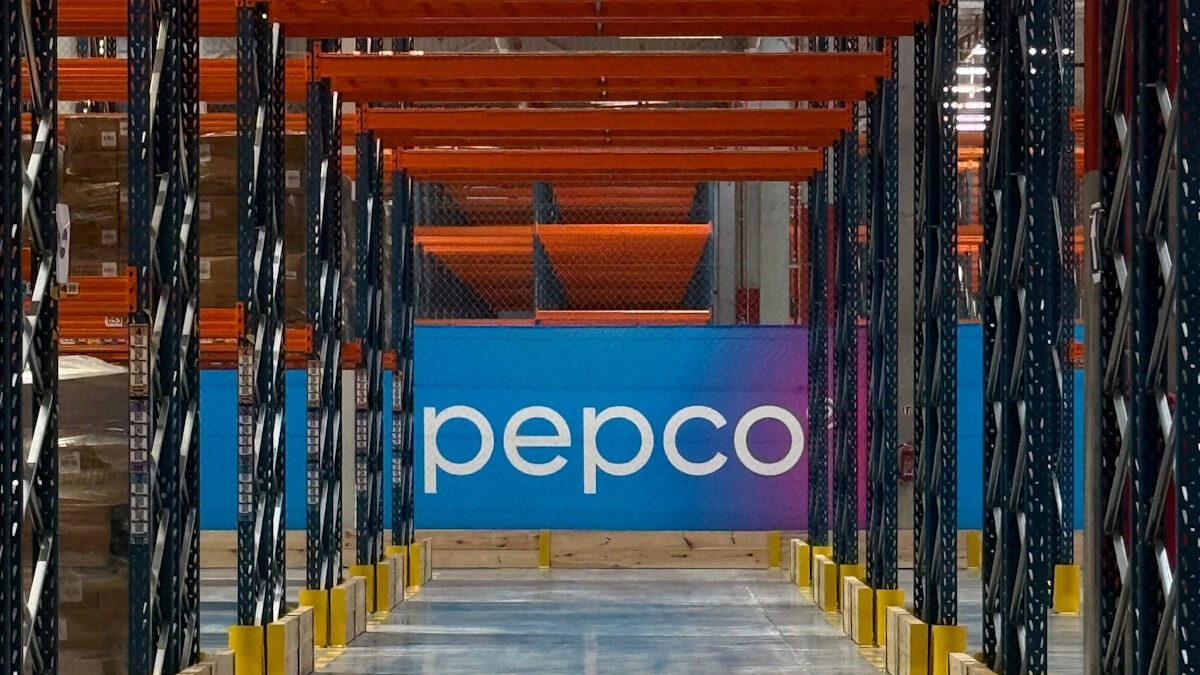 FILE PHOTO: Warehouse workers transport goods between high-bay storage racks inside a new Pepco distribution center in Barniewice near Gdansk, Poland, September 17, 2026.