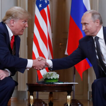 FILE - U.S. President Donald Trump, left, and Russian President Vladimir Putin, right, shake hands at the beginning of a meeting at the Presidential Palace in Helsinki, Finland, July 16, 2018.