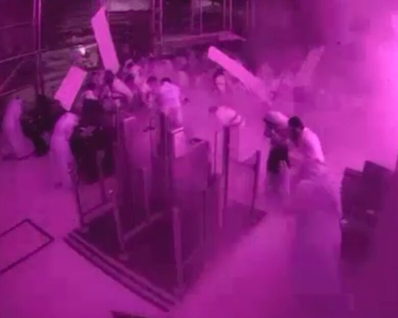 This image from CCTV video released by Saudi Arabia's Media Ministry shows passengers taking cover as flames and smoke fill part of King Khalid International Airport in Riyadh, Saudi Arabia, during what authorities described as a strike at the airport on Saturday, Oct. 10, 2026.