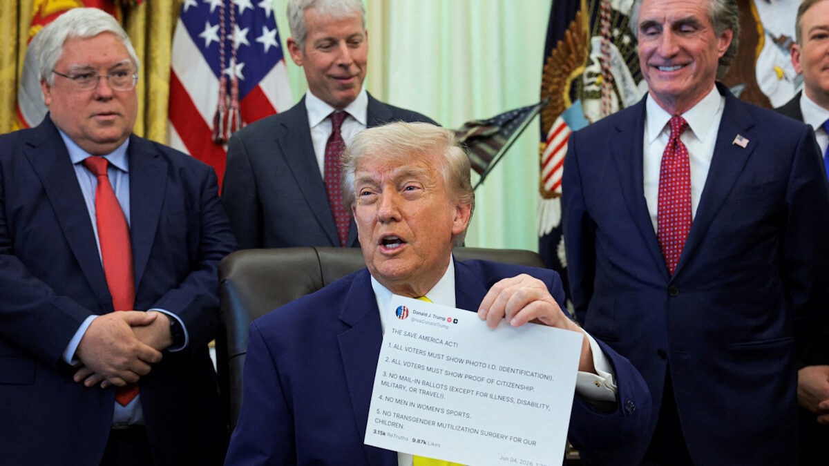 U.S. President Donald Trump shows a printout of his Truth Social post as he delivers remarks to reporters in the Oval Office at the White House in Washington, D.C., U.S., June 4, 2026