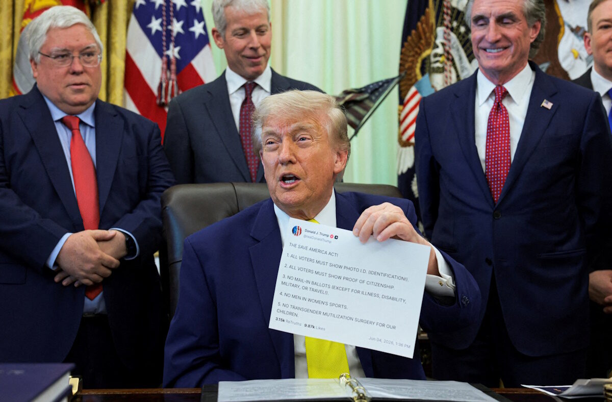 U.S. President Donald Trump shows a printout of his Truth Social post as he delivers remarks to reporters in the Oval Office at the White House in Washington, D.C., U.S., June 4, 2026