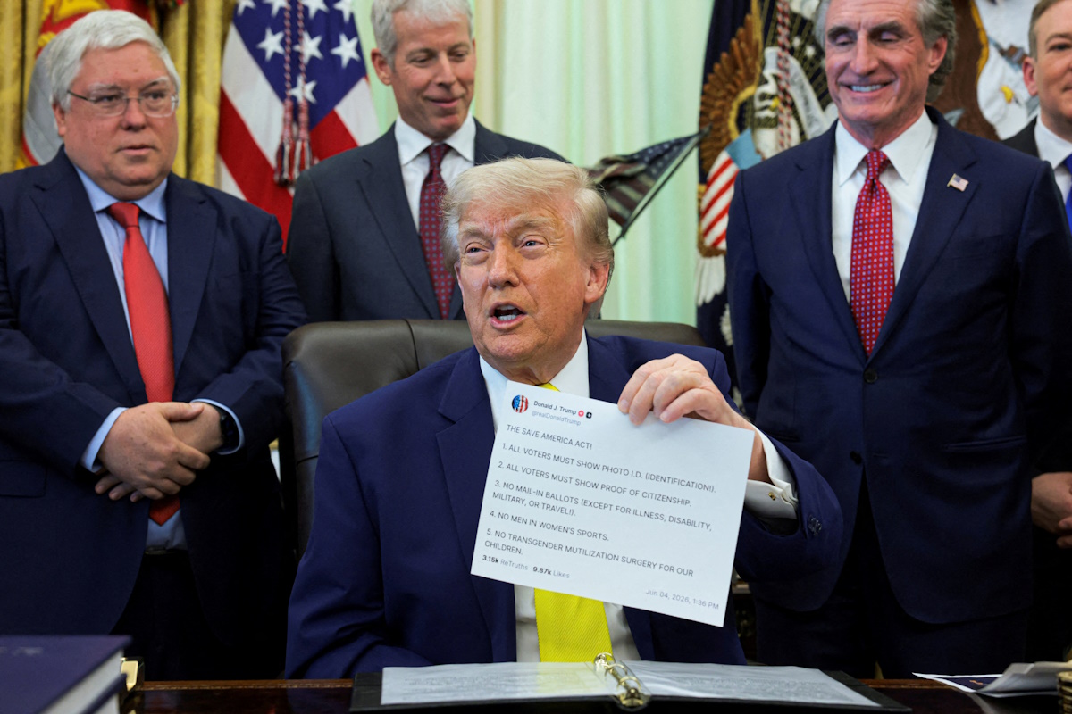 U.S. President Donald Trump shows a printout of his Truth Social post as he delivers remarks to reporters in the Oval Office at the White House in Washington, D.C., U.S., June 4, 2026