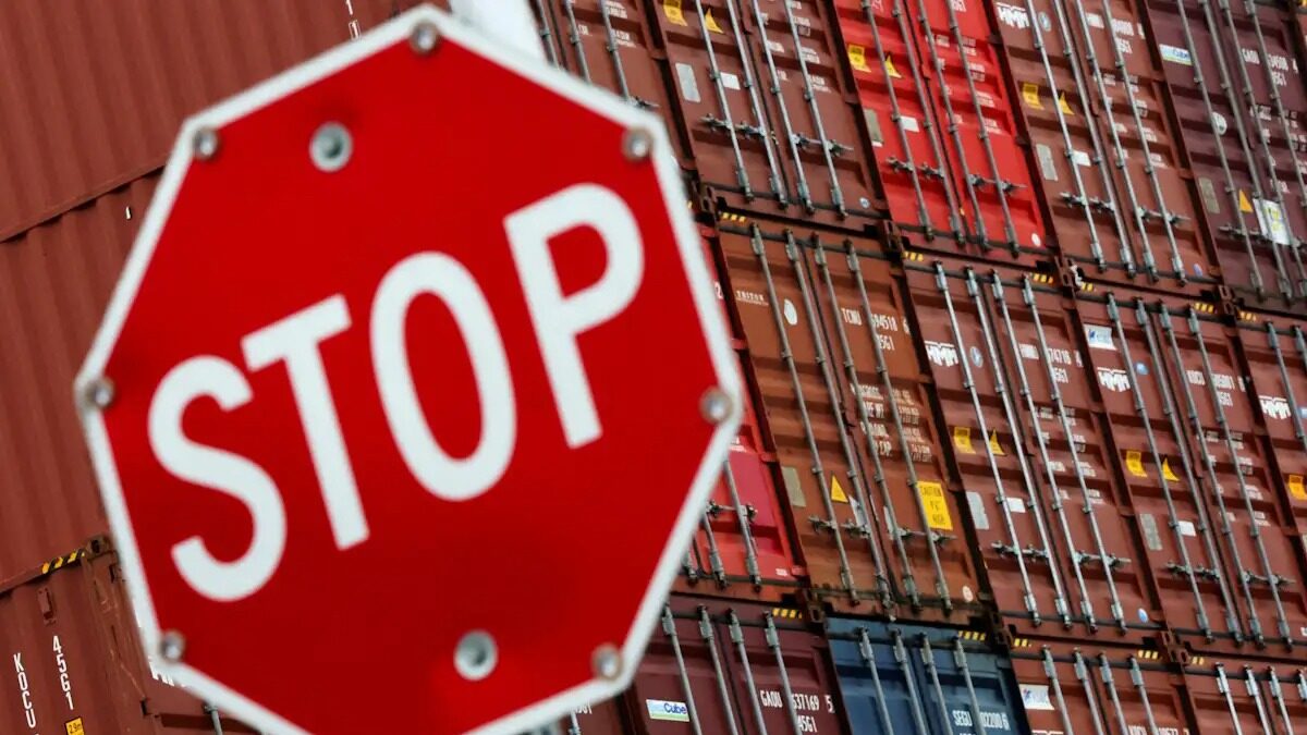 FILE PHOTO: A stop sign is pictured in front of shipping containers at the Port of Long Beach in Long Beach, California, U.S., July 11, 2025.