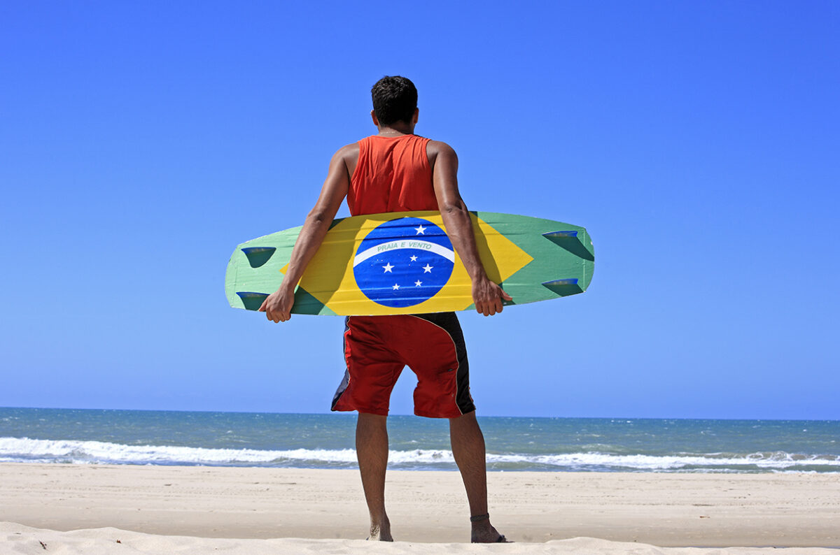 Kitesurfer with the brazilian painted on the board in prainha beach near fortaleza